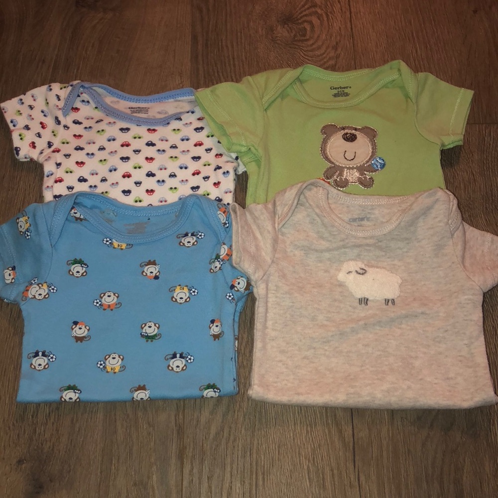 (4) 0-3 onesies Gerber and Caters